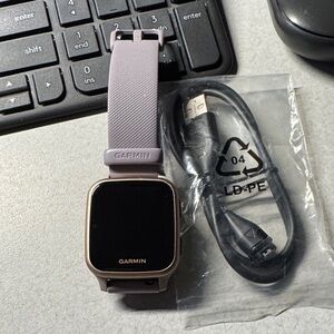 Garmin Watch with Purple Strap and Accessories